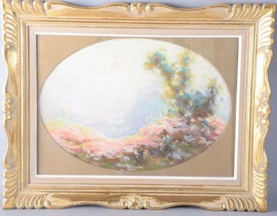 painting of a landscape in a gold frame on a gray wall