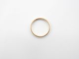 a gold ring on a white surface