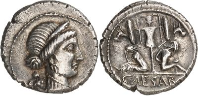 a silver coin with a woman ' s head and a man ' s head on it