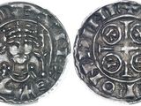 a close up of two silver coins on a white surface