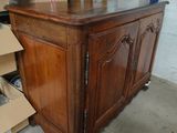 a large wooden cabinet with a clock on top of it