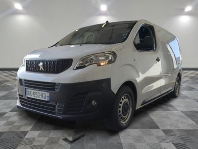 the white van is parked in a large room with a checkered floor