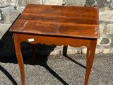 a small wooden table with a small drawer on top of it