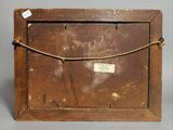 an old wooden box with a label on it and a rope around it