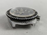 a watch that is sitting on top of a piece of metal