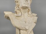 a white marble bust of a woman with long hair