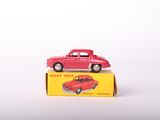 a red toy car sitting on top of a yellow box