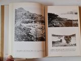 someone is holding a book open to a picture of a mountain
