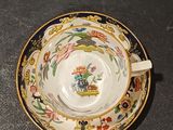 a cup and saucer sitting on a table