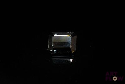 an image of a square cut diamond on a black surface