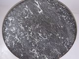 a black and white marble tray on a white table