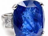 an image of a blue sapphire and diamond ring on a white background