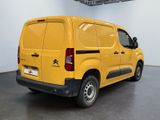 a yellow van that is parked in a room
