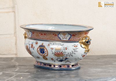a vase with a lion head on it sitting on a table