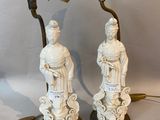 pair of antique chinese figurines with a lamp on a table