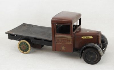 un camion jouet avec une benne sur une surface blanche
