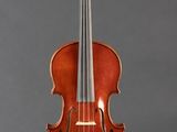 a violin on a stand against a gray background