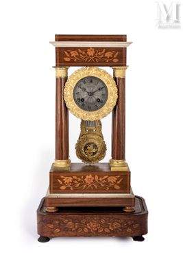 a clock that is sitting on top of a wooden stand