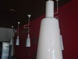 une lampe blanche suspendue au plafond d'un restaurant