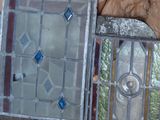 several pieces of stained glass sitting on top of a table next to a stone wall