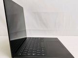 a black laptop with a black keyboard on a white surface