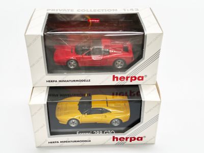 deux petites voitures rouges et jaunes dans une boîte