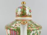 a close up of a vase with a lid on a table