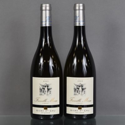 two bottles of wine sitting on top of a table next to each other