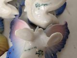 three small figurines of animals sitting on a table