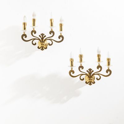 a pair of brass wall sconces in the manner of person