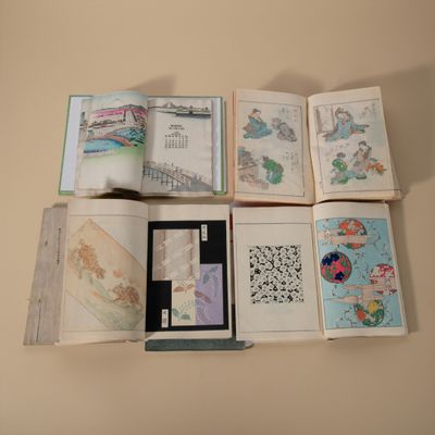 a lot of books that are open on a table