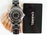 a black watch and a card on a table