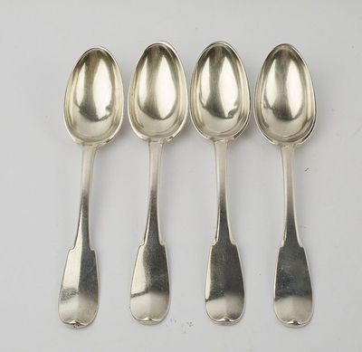 six spoons are lined up in a row on a white surface
