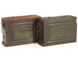 pair of old tins with labels on them sitting on a white surface