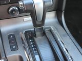 a car dashboard with a metal gear box in the center of it