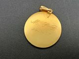 a close up of a gold medal on a black surface