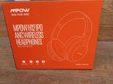 a box of headphones sitting on top of a wooden table