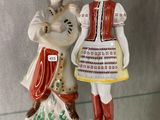 two figurines that are on display in a glass case