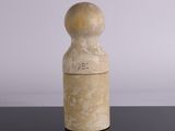 a white vase with a wooden lid sitting on a table