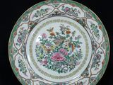 an image of a plate with flowers on it on a black background