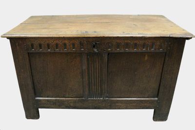 an old wooden chest with two doors and a drawer on top of it