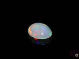 an image of a white fire opal in the dark
