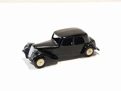 a black toy car sitting on a white surface