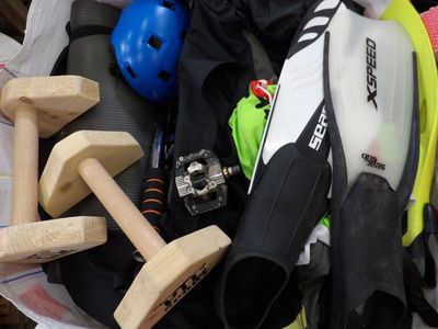 a bucket full of sports gear and a helmet on the table