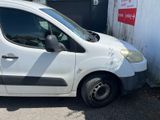 a small white van parked in front of a building