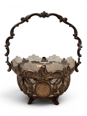 an antique silver plated basket with a handle and handles