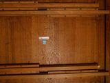 a wooden cabinet with a blue sticker on it