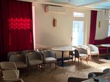 tables and chairs in a room with red drapes on the ceiling