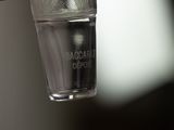 someone is holding a glass of water with a toothbrush in it