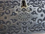 a silver metal box with ornate designs on it